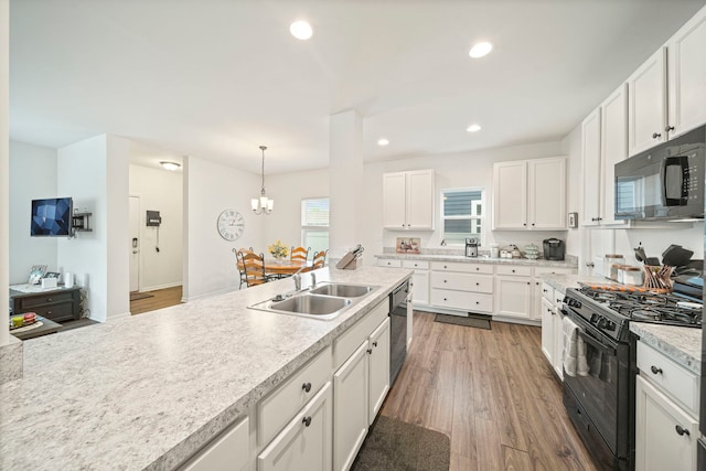 3778 Westbury Ct, Elgin, IL 60124 - kitchen with black appliances, light countertops, white cabinets, recessed lighting, and light wood-style floors