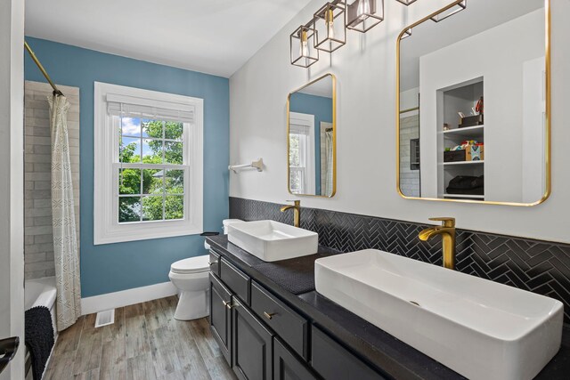 1401 Fallcreek Ct, Naperville, IL 60565 - bathroom featuring double vanity, shower / bathtub combination with curtain, and wood finished floors