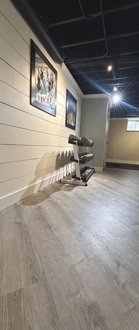 1401 Fallcreek Ct, Naperville, IL 60565 - basement featuring wooden walls and wood finished floors