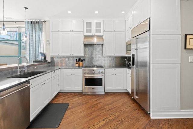 841 W Monroe St Unit 4A, Chicago, IL 60607 - kitchen featuring high end appliances, under cabinet range hood, white cabinetry, dark wood-style floors, and recessed lighting