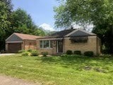 2075 Halsey Dr, Des Plaines, IL 60018 - view of front of property with an attached garage and a front lawn
