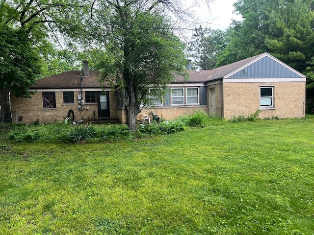 2075 Halsey Dr, Des Plaines, IL 60018 - view of front of home featuring brick siding, a front lawn, and a chimney