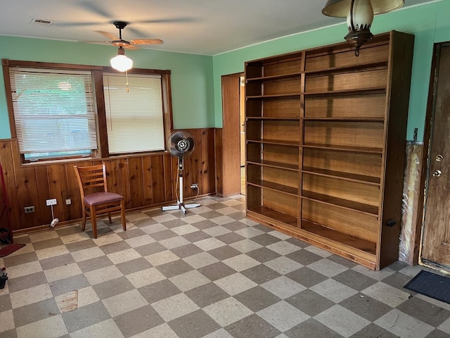 2075 Halsey Dr, Des Plaines, IL 60018 - living area with wainscoting, a ceiling fan, light flooring, and wood walls