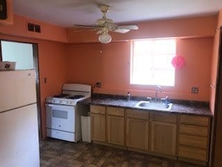 2075 Halsey Dr, Des Plaines, IL 60018 - kitchen with white appliances, ceiling fan, and dark countertops
