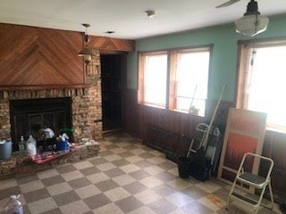 2075 Halsey Dr, Des Plaines, IL 60018 - living room featuring tile patterned floors, wood walls, and a fireplace