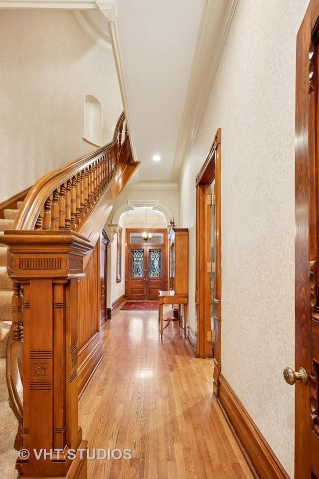 2124 N Cleveland Ave, Chicago, IL 60614 - hall featuring ornamental molding, light wood finished floors, arched walkways, a chandelier, and stairway