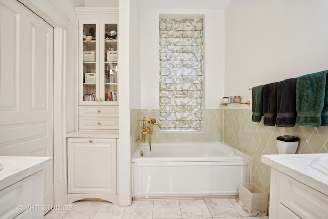 2124 N Cleveland Ave, Chicago, IL 60614 - full bathroom with vanity, a garden tub, wainscoting, and tile walls
