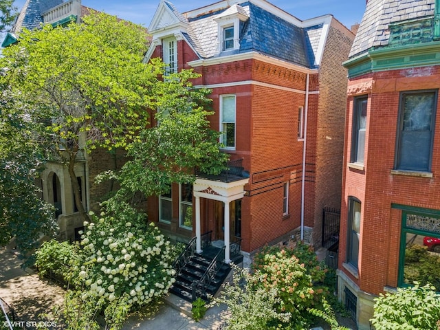 2124 N Cleveland Ave, Chicago, IL 60614 - view of front facade with a high end roof, mansard roof, and brick siding