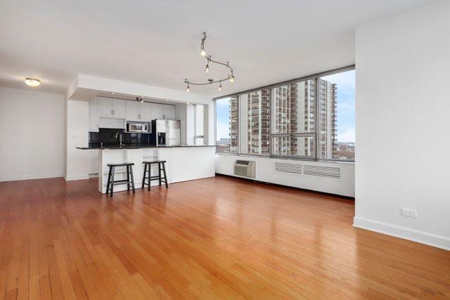 70 W Burton Pl Unit 1801, Chicago, IL 60610 - living area featuring wood finished floors and a wall mounted air conditioner