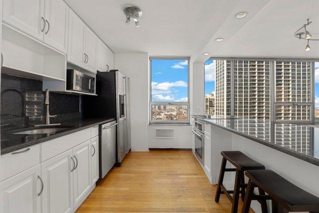 70 W Burton Pl Unit 1801, Chicago, IL 60610 - kitchen featuring appliances with stainless steel finishes, open shelves, white cabinetry, light wood-style flooring, and recessed lighting