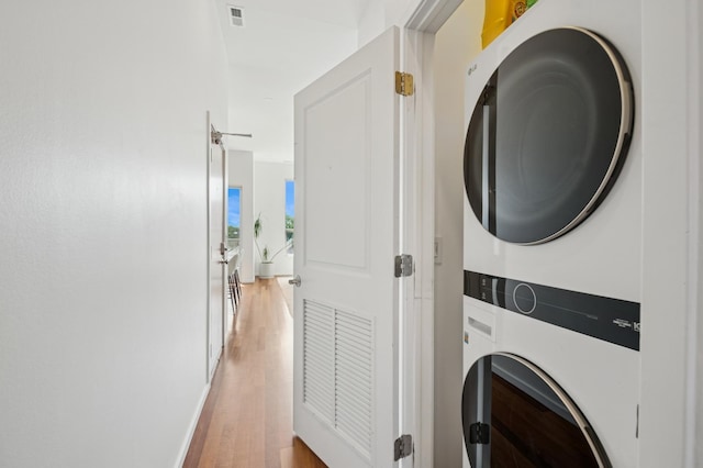 1719 N Western Ave Unit 4, Chicago, IL 60647 - laundry area featuring stacked washing machine and dryer and light wood finished floors
