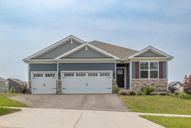 738 Kentshire Cir, Elgin, IL 60124 - craftsman-style house with stone siding, asphalt driveway, a front yard, and an attached garage