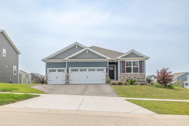 738 Kentshire Cir, Elgin, IL 60124 - craftsman house featuring stone siding, a front yard, concrete driveway, and an attached garage