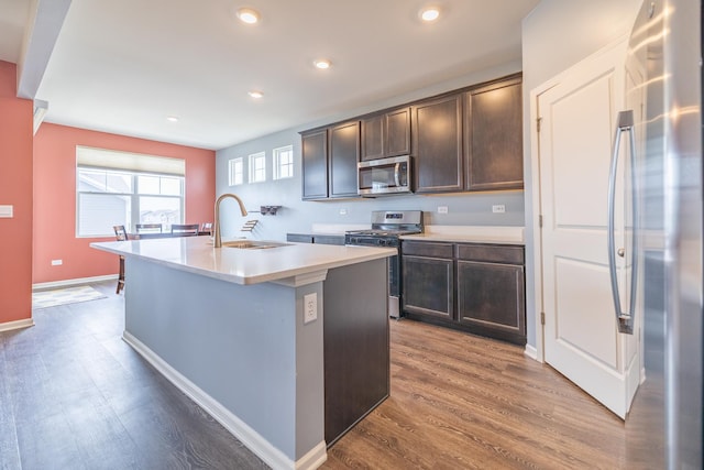 738 Kentshire Cir, Elgin, IL 60124 - kitchen featuring appliances with stainless steel finishes, dark wood-style flooring, dark brown cabinetry, an island with sink, and recessed lighting