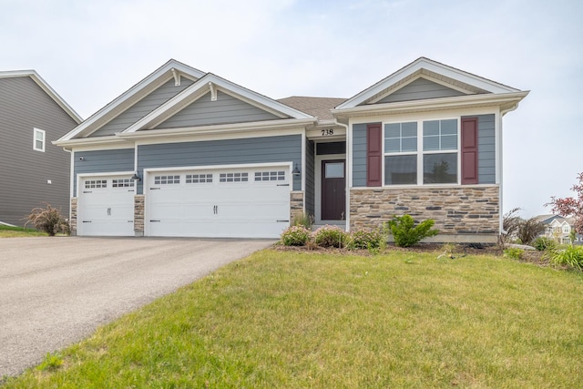 738 Kentshire Cir, Elgin, IL 60124 - view of front of property with stone siding, a front lawn, driveway, and an attached garage