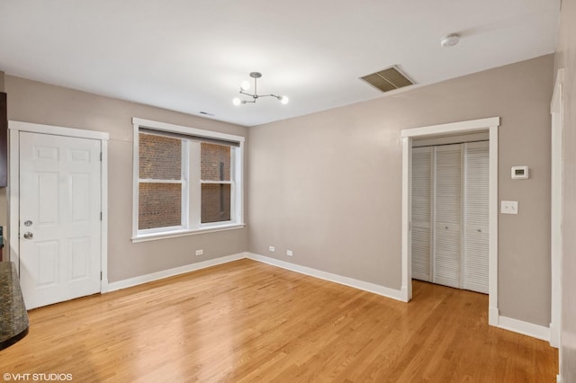 2305 N Kimball Ave Unit 1, Chicago, IL 60647 - unfurnished dining area with light wood-type flooring and a chandelier