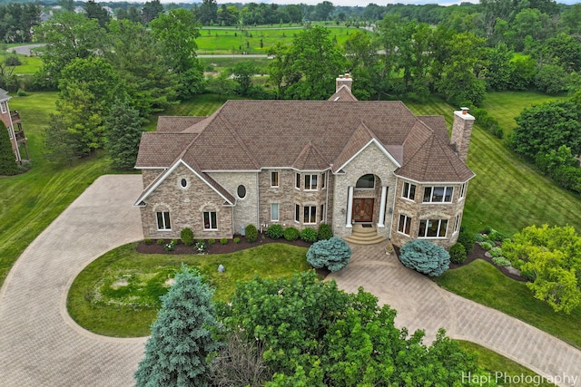 39 Forest Ln, South Barrington, IL 60010 - view of front of house featuring stone siding, a chimney, and curved driveway