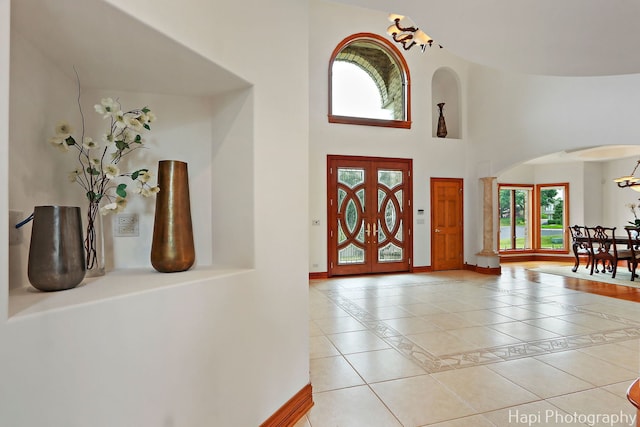 39 Forest Ln, South Barrington, IL 60010 - entryway featuring arched walkways, light tile patterned floors, healthy amount of natural light, a high ceiling, and inlaid floor details
