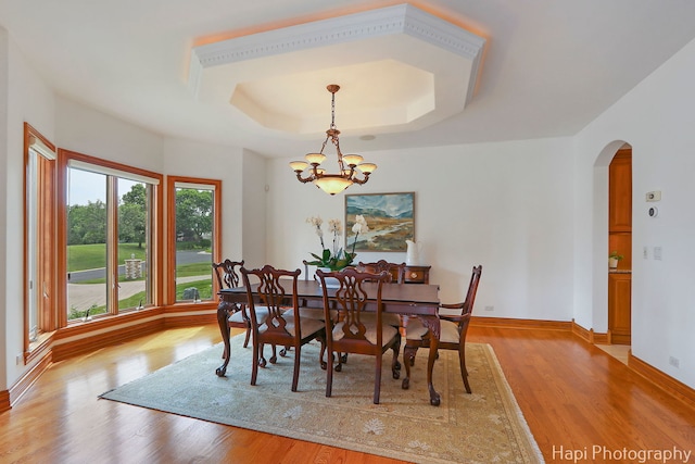 39 Forest Ln, South Barrington, IL 60010 - dining area featuring arched walkways, light wood-style floors, a chandelier, and a tray ceiling