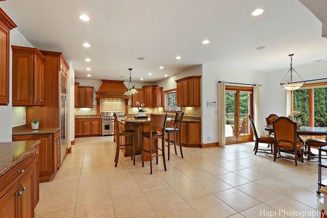 39 Forest Ln, South Barrington, IL 60010 - kitchen featuring high quality appliances, custom range hood, brown cabinetry, plenty of natural light, and recessed lighting