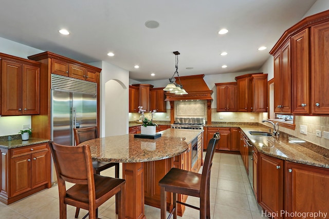 39 Forest Ln, South Barrington, IL 60010 - kitchen featuring premium range hood, a kitchen island, recessed lighting, stainless steel built in refrigerator, and backsplash