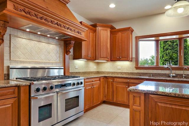 39 Forest Ln, South Barrington, IL 60010 - kitchen featuring range with two ovens, custom exhaust hood, stone counters, brown cabinets, and recessed lighting