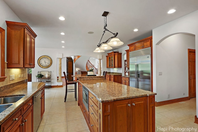 39 Forest Ln, South Barrington, IL 60010 - kitchen with built in appliances, arched walkways, light tile patterned flooring, and recessed lighting