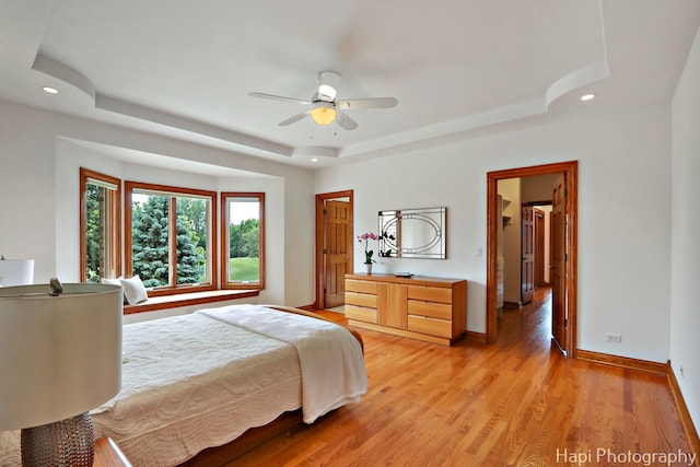 39 Forest Ln, South Barrington, IL 60010 - bedroom with a raised ceiling, recessed lighting, light wood-style flooring, and ceiling fan