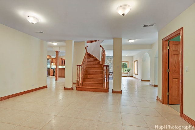 39 Forest Ln, South Barrington, IL 60010 - stairway featuring tile patterned floors, ornate columns, and arched walkways