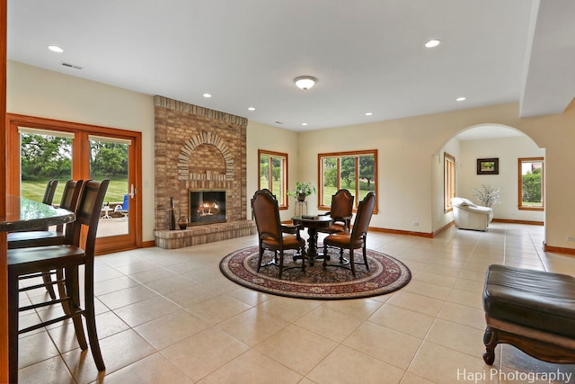 39 Forest Ln, South Barrington, IL 60010 - dining area with light tile patterned floors, arched walkways, plenty of natural light, a fireplace, and recessed lighting