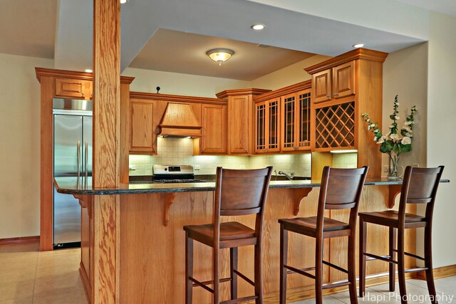 39 Forest Ln, South Barrington, IL 60010 - kitchen featuring custom range hood, appliances with stainless steel finishes, glass insert cabinets, tasteful backsplash, and recessed lighting