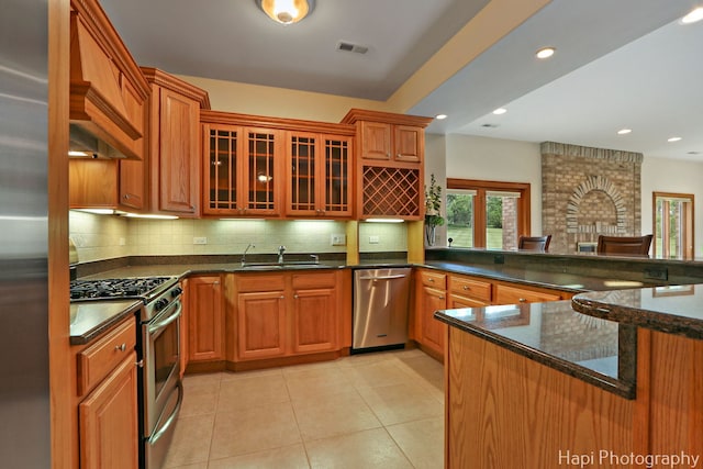 39 Forest Ln, South Barrington, IL 60010 - kitchen with appliances with stainless steel finishes, tasteful backsplash, glass insert cabinets, dark stone countertops, and light tile patterned flooring