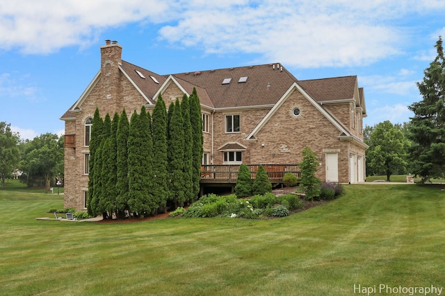 39 Forest Ln, South Barrington, IL 60010 - view of side of home with a chimney, a lawn, a deck, brick siding, and a garage