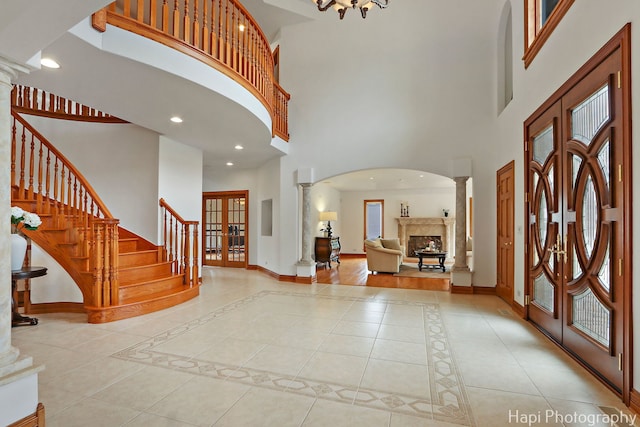 39 Forest Ln, South Barrington, IL 60010 - foyer featuring french doors, a high ceiling, ornate columns, stairs, and arched walkways