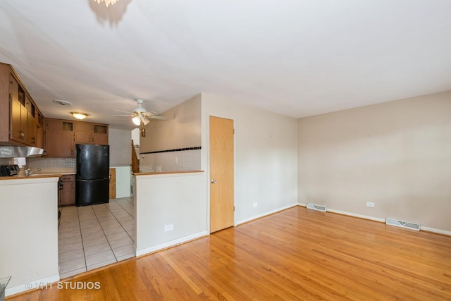 4912 W 32nd St, Cicero, IL 60804 - kitchen with freestanding refrigerator, ceiling fan, light countertops, backsplash, and light wood finished floors
