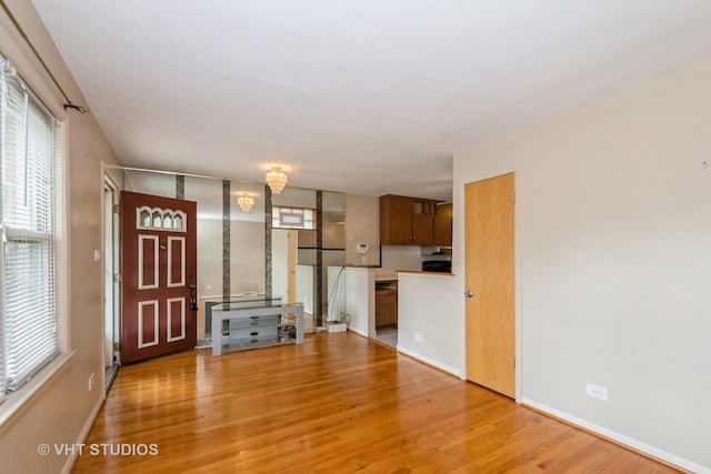 4912 W 32nd St, Cicero, IL 60804 - unfurnished living room with light wood finished floors and baseboards