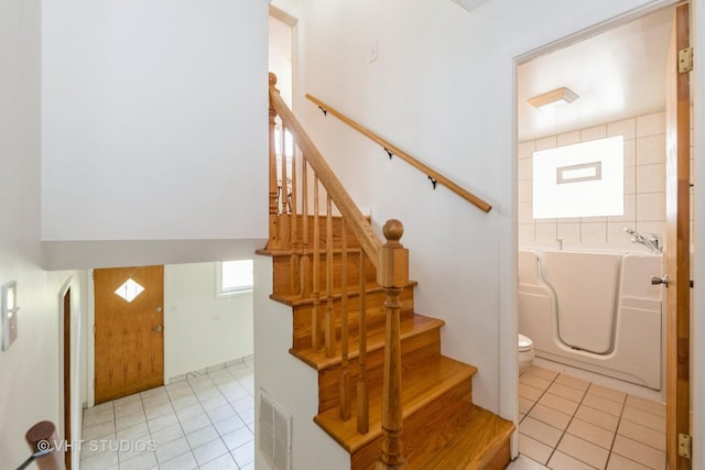 4912 W 32nd St, Cicero, IL 60804 - staircase featuring tile patterned flooring and arched walkways