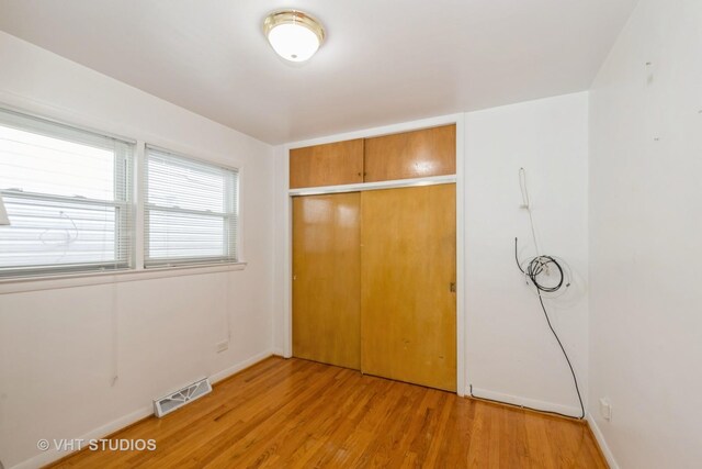 4912 W 32nd St, Cicero, IL 60804 - unfurnished bedroom with light wood-style floors and a closet