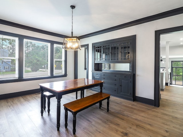 246 S Oak St, Itasca, IL 60143 - dining space with a chandelier, wood finished floors, and crown molding