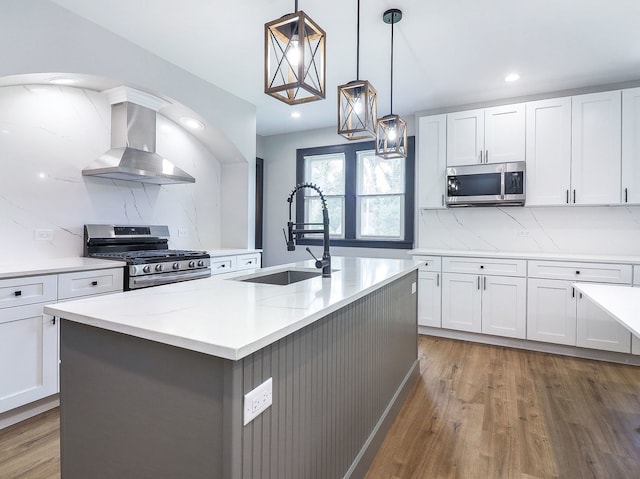 246 S Oak St, Itasca, IL 60143 - kitchen with wall chimney range hood, appliances with stainless steel finishes, white cabinets, tasteful backsplash, and recessed lighting