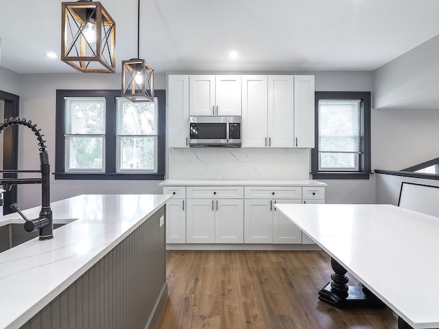 246 S Oak St, Itasca, IL 60143 - kitchen featuring stainless steel microwave, white cabinets, dark wood-style flooring, hanging light fixtures, and recessed lighting
