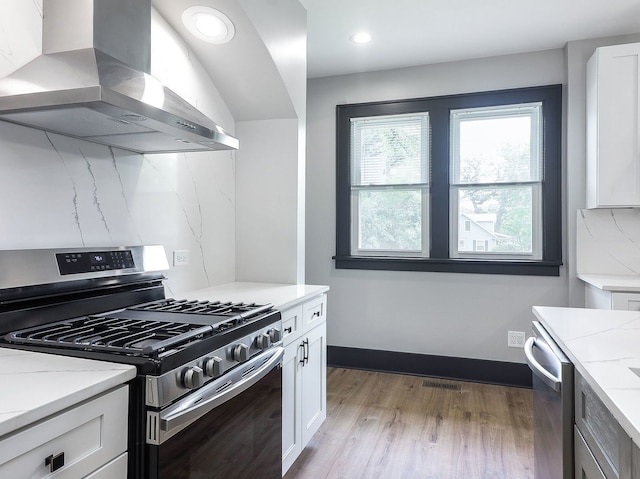 246 S Oak St, Itasca, IL 60143 - kitchen with stainless steel appliances, wall chimney exhaust hood, light wood finished floors, white cabinetry, and recessed lighting