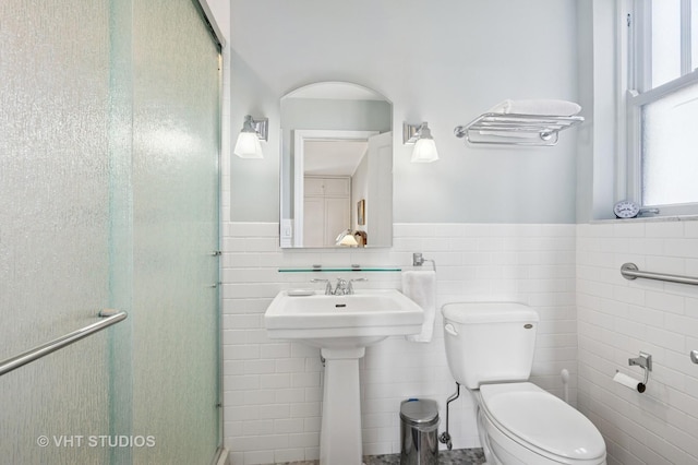 2440 N Lakeview Ave Unit 14E, Chicago, IL 60614 - full bathroom featuring tile walls, a shower stall, and wainscoting