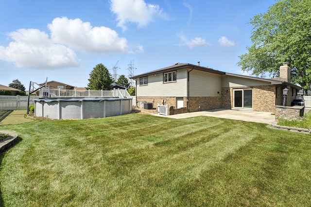 12449 W Prairie Dr, Homer Glen, IL 60491 - back of house featuring a chimney, brick siding, a covered pool, and a patio