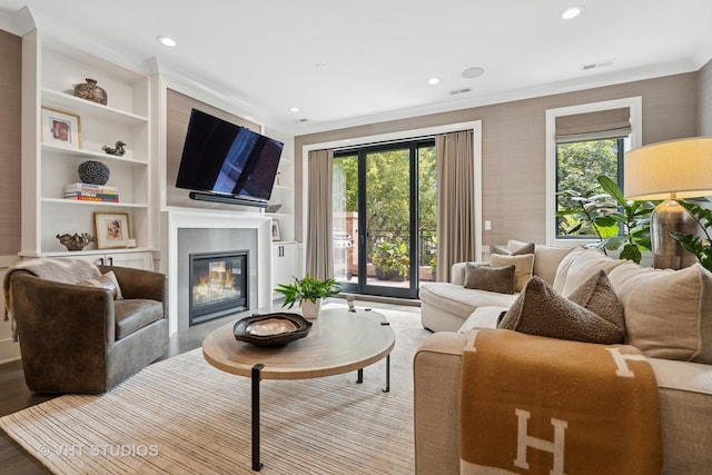 2724 N Wayne Ave Unit 3, Chicago, IL 60614 - living area featuring a glass covered fireplace, crown molding, built in shelves, recessed lighting, and wood finished floors