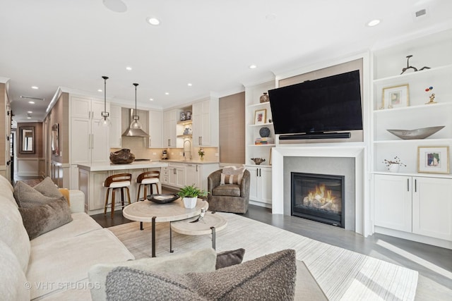 2724 N Wayne Ave Unit 3, Chicago, IL 60614 - living area with recessed lighting, a glass covered fireplace, built in shelves, and light wood-style floors