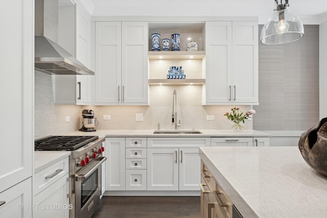 2724 N Wayne Ave Unit 3, Chicago, IL 60614 - kitchen featuring wall chimney exhaust hood, high end stove, white cabinetry, and tasteful backsplash