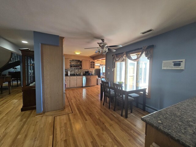 501 Kingston Blvd, Mchenry, IL 60050 - sitting room with wood finished floors, plenty of natural light, a textured ceiling, a baseboard radiator, and a wall unit AC