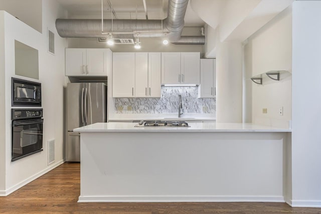 130 S Canal St Unit 624, Chicago, IL 60606 - kitchen featuring black appliances, light countertops, white cabinetry, and dark wood finished floors