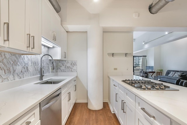 130 S Canal St Unit 624, Chicago, IL 60606 - kitchen featuring appliances with stainless steel finishes, light wood-style floors, decorative backsplash, and white cabinetry